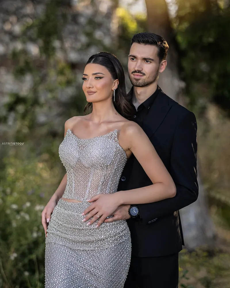 Portrait of a couple, a woman in a beaded silver gown and a man in black